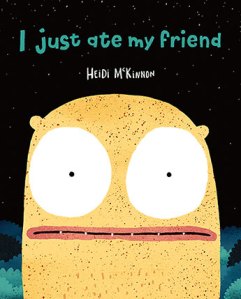 I just ate my friend by Heidi McKinnon. Image: Front cover of picture book. Black background and title of book is in teal. Illustration is a giant yellow alien head with owl like enormous white eyes. 
