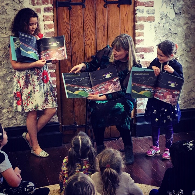 Amber reading with some helpers at the book launch