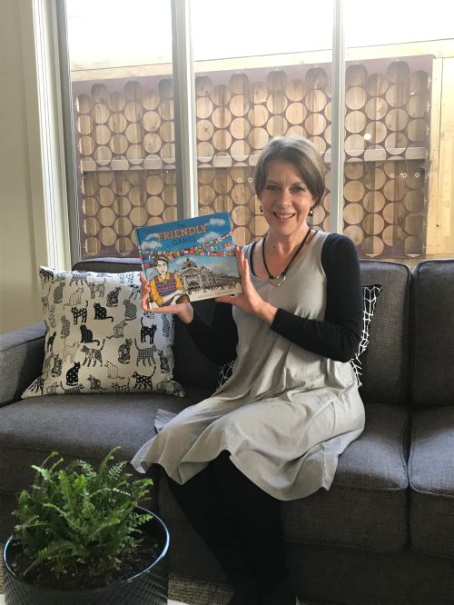 Kaye Baillie holding her book THE FRIENDLY GAMES