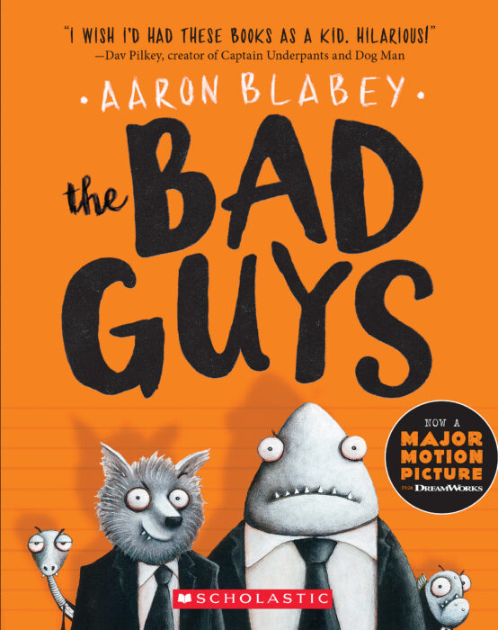 Image shows the cover of a children's graphic novel: The Bad Guys by Aaron Blabey. The cover's background is bright orange. At the bottom of the book's cover are cartoon illustrations in black and white and grey showing a snake, a wolf wearing a suit and tie, a shark wearing a suit and tie and a piranha.