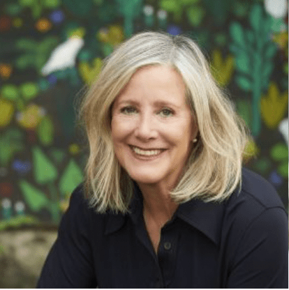 Frané Lessac, author and illustrator. Frané has pale skin and shoulder length blonde hair, she is smiling at the camera.