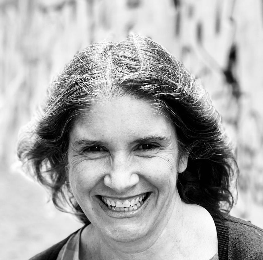 A head and shoulders photo of a woman smiling broadly