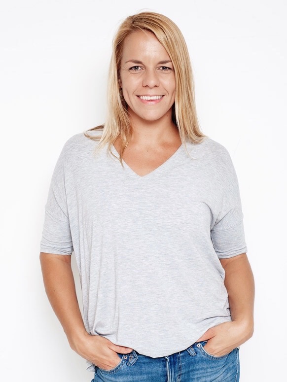 A photo of Nat Amoore standing with her hands in the pockets of her jeans