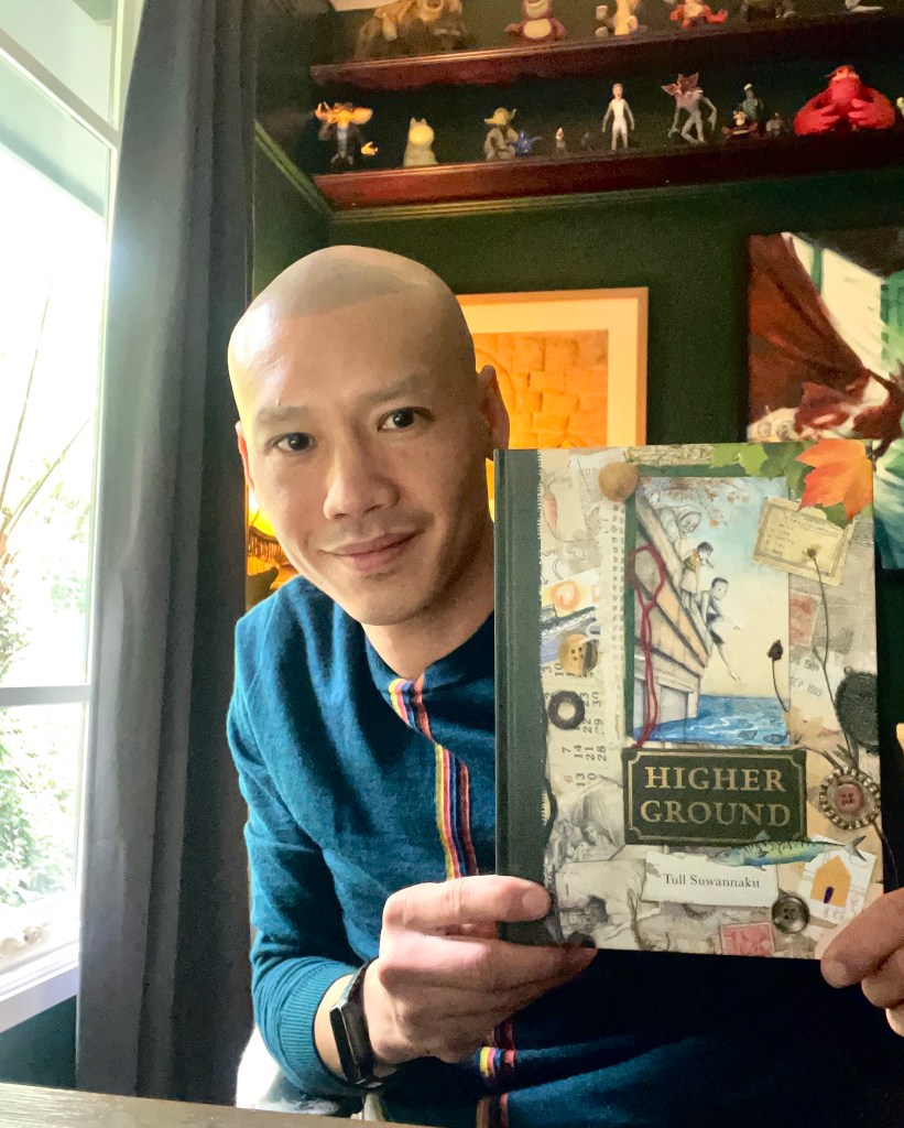 Tull Suwannakit holds up a copy of Higher Ground