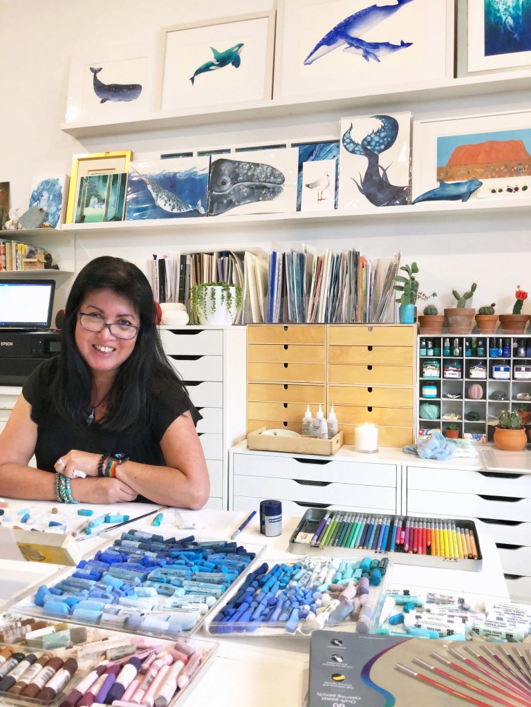 Cindy Lane in her studio surrounded by art supplies