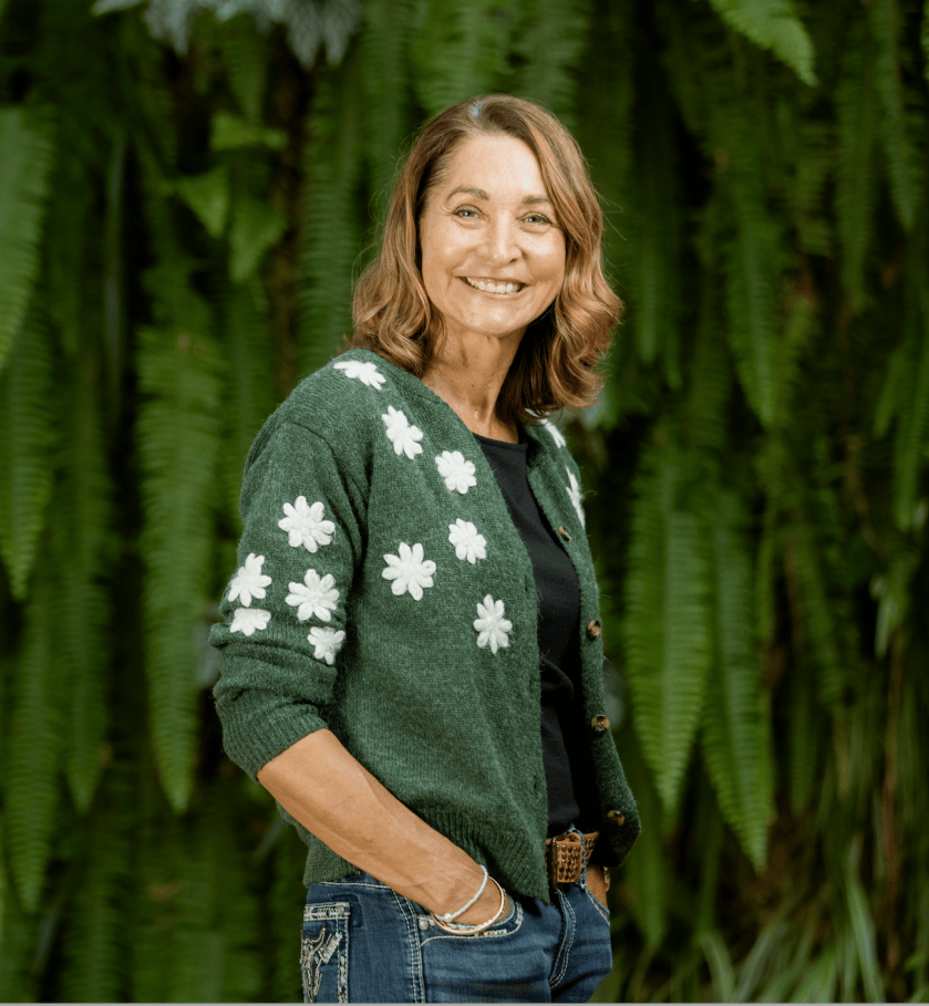 Samantha Wheeler, a woman with shoulder length hair, stands with hands in pockets. 
